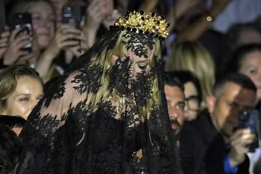 Madonna stands at the end of the Dolce & Gabbana Spring Summer 2025 fashion show, that was presente…