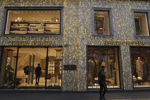 A man walks past a shop in Monte Napoleone street in Milan, Italy, Thursday, December 12, 2024