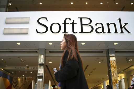 A woman walks in front of SoftBank store in Ginza shopping district in Tokyo, January 20, 2020