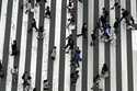 People walk along a pedestrian crossing at Ginza shopping street in Tokyo, on March 31, 2023, in To…