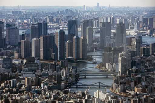 An aerial view of the skyscrapers and the densely packed buildings are seen on January 29, 2021, fr…