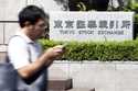 A person walks in front of the Tokyo Stock Exchange building Wednesday, October 2, 2024, in Tokyo