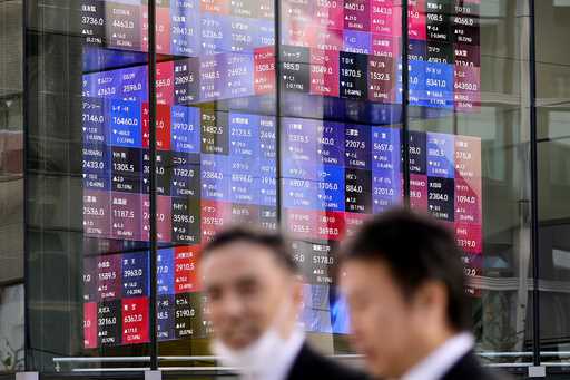 A person walks in front of the Tokyo Stock Exchange building at a securities firm Tuesday, November…