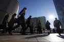 Commuters walk in a passageway during a rush hour at Shinagawa Station, February 14, 2024, in Tokyo…