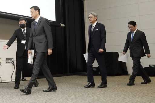 Nissan Chief Executive Makoto Uchida, left, and Honda Chief Executive Toshihiro Mibe, center, and T…