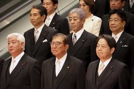 Japanese Prime Minister Shigeru Ishiba, bottom center, accompanied by his new cabinet members poses…