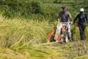 A farmer operates harvester machine on a rice terrace during harvest in Kamimomi village, Okayama p…