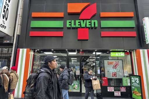 People shop at a 7-Eleven convenience store in New York, Tuesday, March 19, 2024