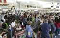 Passengers are seen at the international flight terminal at the Haneda airport, in Tokyo, Japan, as…