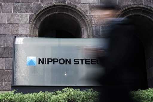 A person walks past a Nippon Steel Corporation sign at the company headquarters Tuesday, January 7,…