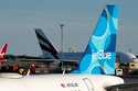 A JetBlue airplane is seen parked on the tarmac at John F