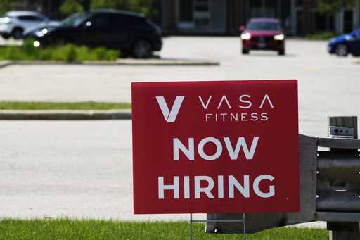 A hiring sign is displayed in Northbrook, Ill