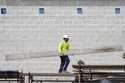 A construction worker walks on scaffolding at a building site on Sept