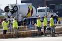 Construction crew members wait to pour concrete in a parking lot on Sept