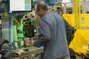 An employee uses an automated packaging machine to create a made-to-measure bag for a book at Amazo…