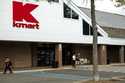 A large Kmart sign is displayed in front of a shopping plaza in Avenel, N