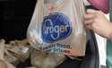 A customer moves purchases at a Kroger grocery store in Flowood, Miss