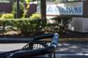 A grocery cart rests in a cart return area with a sign for Albertsons grocery store in the backgrou…