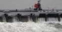 Workers open bays of the Bonnet Carre Spillway to divert rising water from the Mississippi River to…