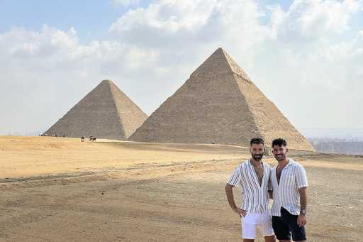 This 2023 photo shows Stefan Arestis, right, and Sebastien Chaneac, at the Pyramids in Egypt