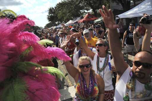 Hundreds of people line Central Avenue and cheer during the 10th Annual St