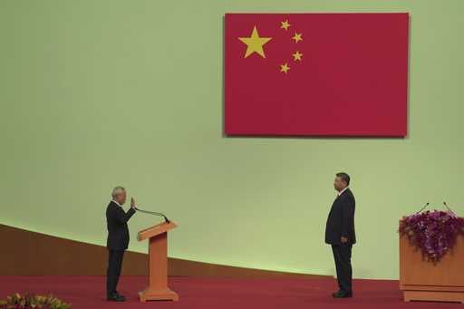 Macao's new leader Sam Hou Fai, left, is sworn in by China's President Xi Jinping during an inaugur…