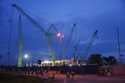 Construction workers walk outside a data center building under construction in Johor Bahru town at …