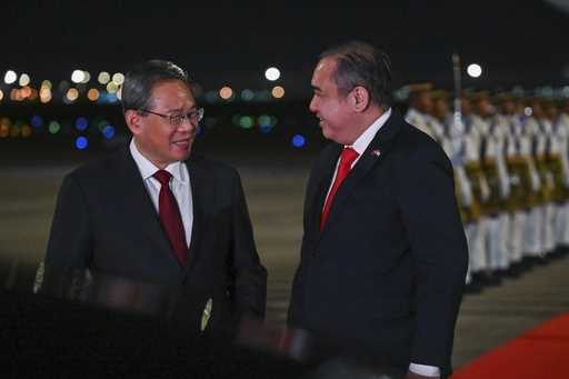 In this photo released by Malaysia's Department of Information, China's Premier Li Qiang, left, is …