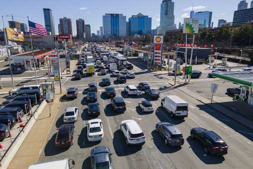 Commuters wait to drive through the Holland Tunnel into New York City during morning rush hour traf…