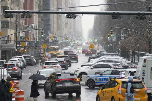 Devices used for congestion tolling hang above traffic on a Manhattan street in New York, Monday, J…