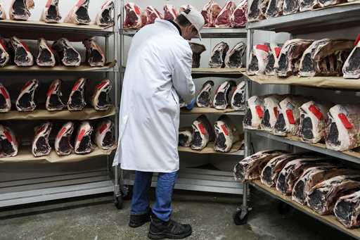 John Jobbagy shows dry aged beef during an interview at J