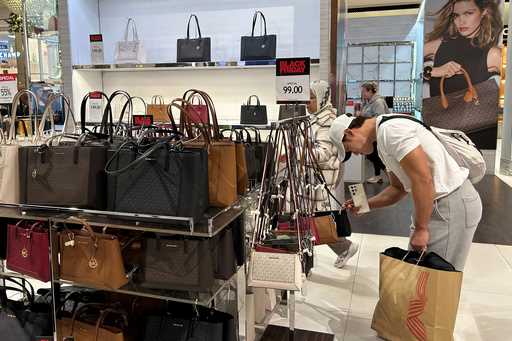 A shopper looks at handbags at Macy's department store on Sunday, November 24, 2024, in New York