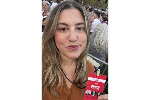 This undated photo provided by Marisa Kabas shows Kabas holding up a press credential on October 4,…