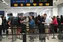 Travelers move through a security checkpoint in Denver International Airport ahead of the Memorial …