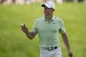 Rory McIlroy, of Northern Ireland, gestures after putting on the 17th green during the first round …