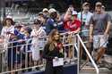 Bally reporter, Hanna Yates, broadcasts her pregame with fans standing behind her waiting for autog…