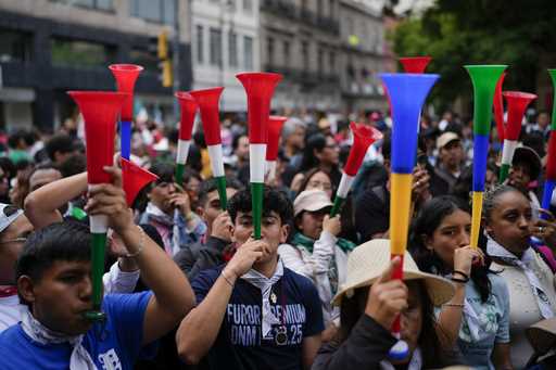 People blows vuvuzelas during a rally in favor of the government's proposed judicial reform outside…