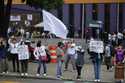 Unionized federal court workers hold signs and shout slogans as they strike over reforms that would…