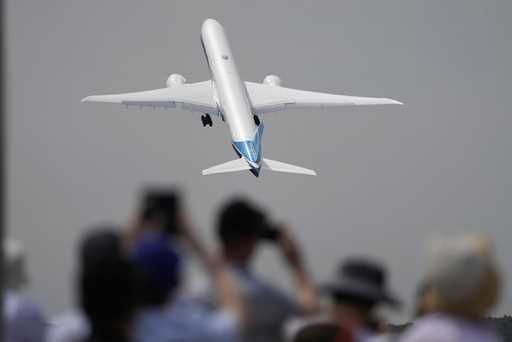 A Boeing 777X plane takes off at the Farnborough Air Show fair in Farnborough, England, on July 18,…