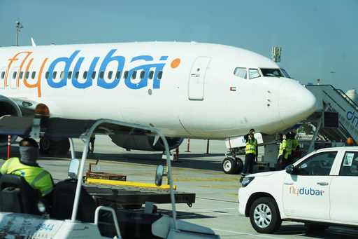 Workers prepare a FlyDubai flight at Dubai International Airport in Dubai, United Arab Emirates, Fr…