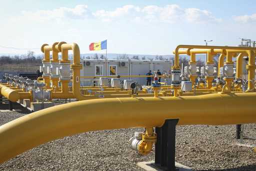 Men stand next to pipelines of the national natural gas distribution network outside Ungheni, Moldo…