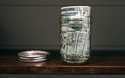 A canning jar filled with money sits on a shelf in East Derry, N