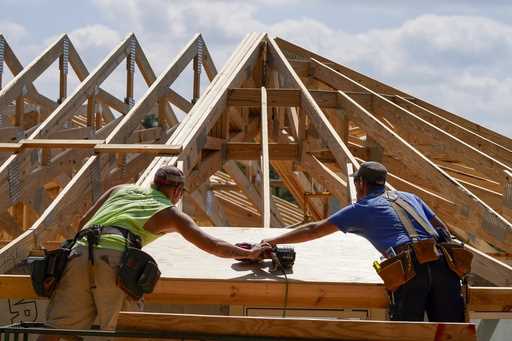 File - Carpenters work on a home on Sept