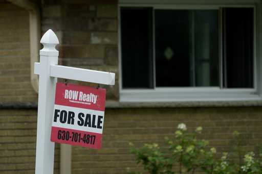 A for sale sign is displayed in front of a home in Evanston, Ill