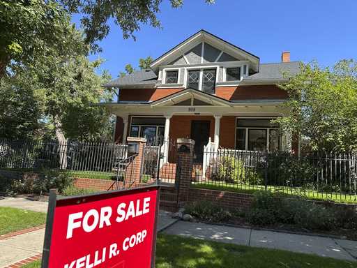 A for sale sign stands outside a home on the market in the Alamo Placita neighborhood Tuesday, Augu…