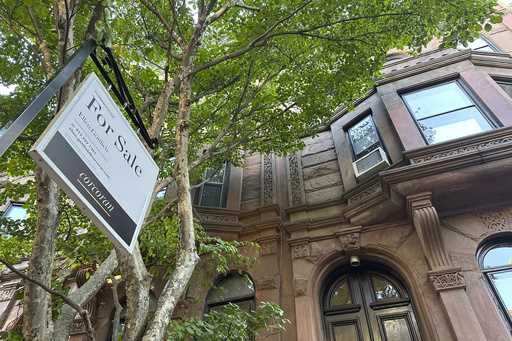 A for sale sign hangs in front of a home in the Park Slope neighborhood in the borough of Brooklyn …