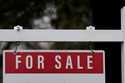 A for sale sign stands outside a residence in Wheeling, Ill