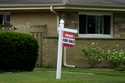 A "For Sale" sign is displayed in front of a home in Evanston, Ill