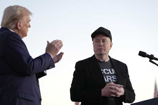 Republican presidential nominee former President Donald Trump, left, claps as Tesla and SpaceX CEO …