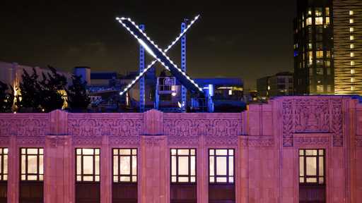 Workers install lighting on an 